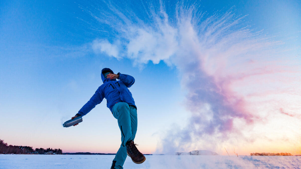 A hiker throws a bottle full of boiling water in the air. Rapid freezing happens when the temperature difference is big enough. (Shutterstock/ File Photo)