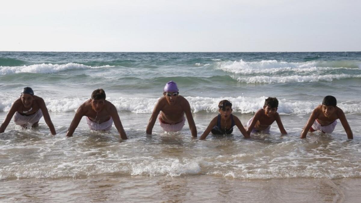 Palestinian children, members of a swimming club, participate in a training session in Beit Lahia in the northern Gaza Strip, on October 4, 2018. (SAID KHATIB / AFP)