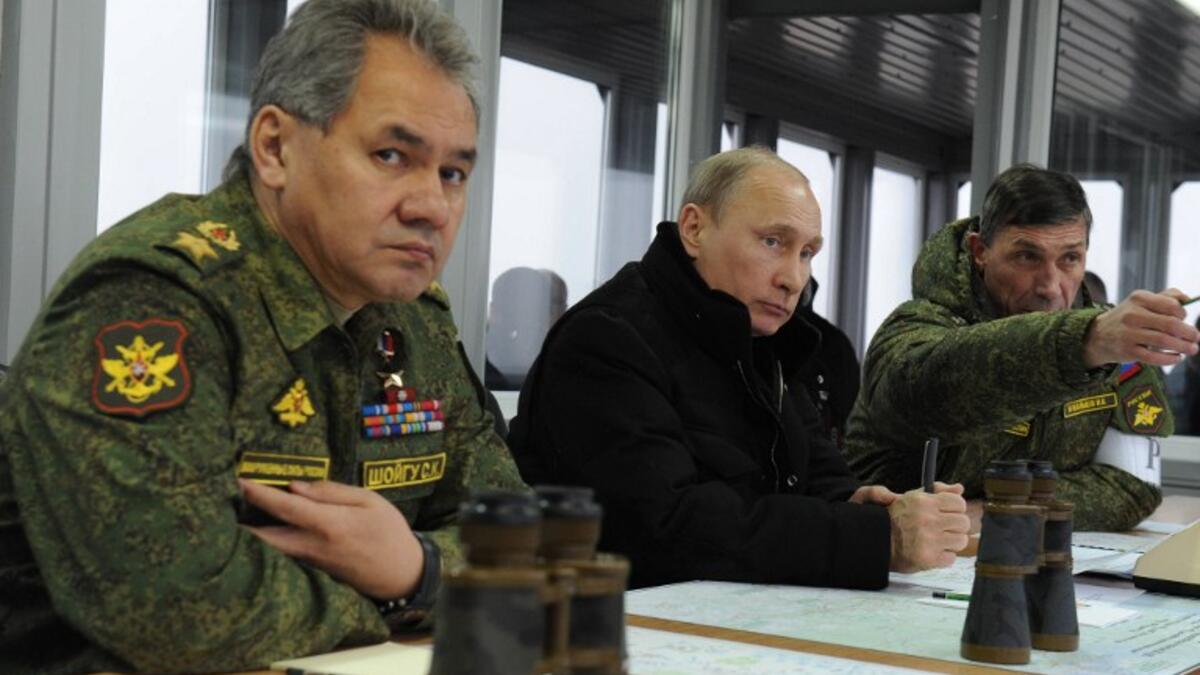 President Putin with Defence Minister Sergei Shoigu watching military exercises at the Kirillovsky firing ground in the Leningrad region, on March 3, 2014.(AFP PHOTO/ RIA-NOVOSTI/ POOL/ MIKHAIL KLIMENTYEV)