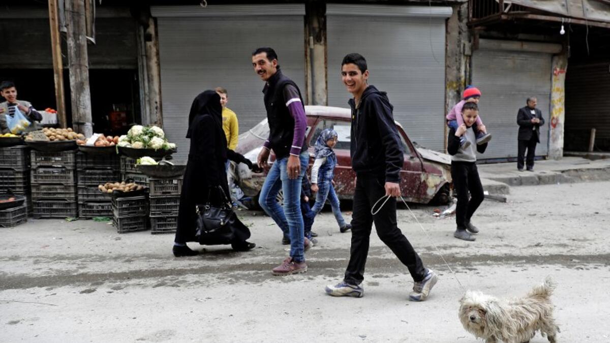Life going back to normal. A Syrian man walks his dog in the previously rebel-held al-Shaar neighborhood in the northern city of Aleppo on March 10, 2017.