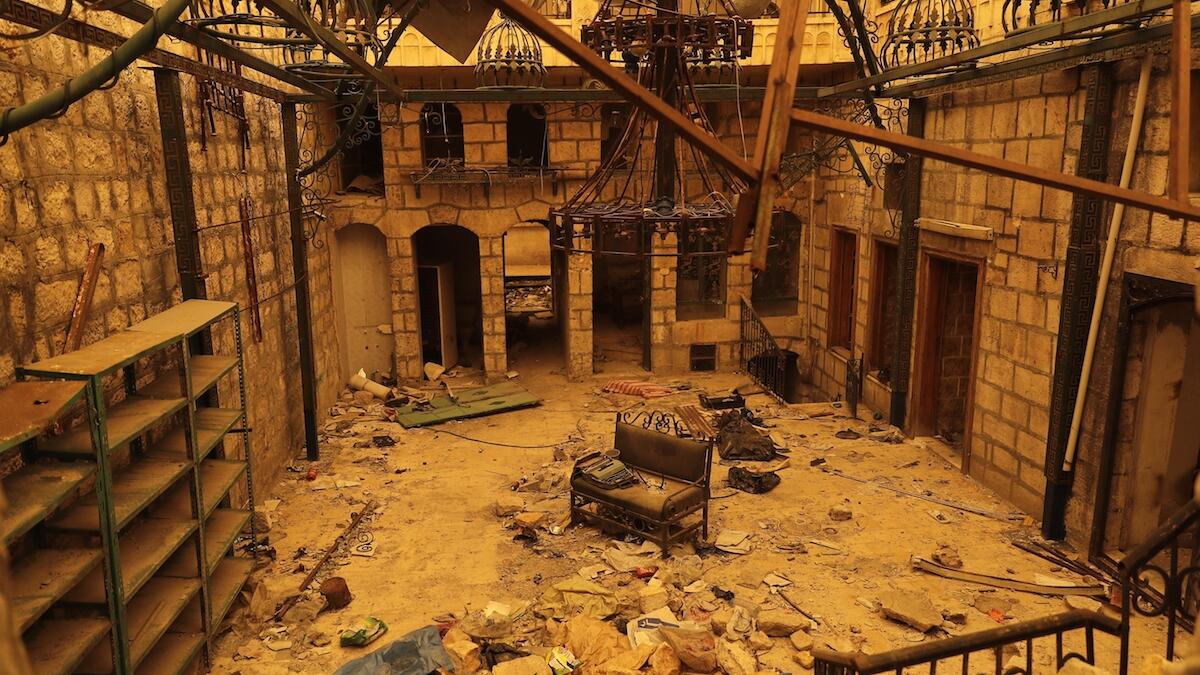 The interior of a damaged building is seen during a sandstorm in Aleppo, Syria. Following a long government siege, the city has barely an hour of electricity a day with generators operating here and there.