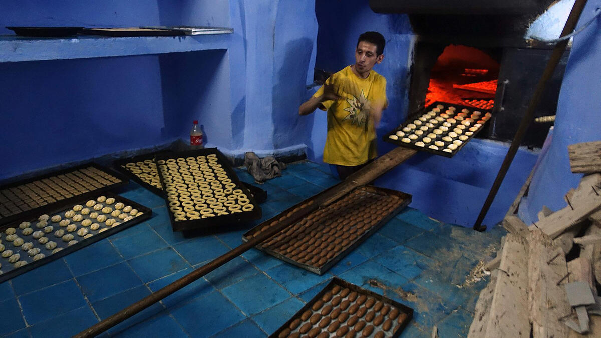 Cookies and sweets are prepared ahead of Eid festivities. While previously families used to do them at home, nowadays many buy them from the market. Here, a man bakes biscuits in the northwestern Moroccan city of Chefchaouen, in the Rif mountains, on June 20, 2017.