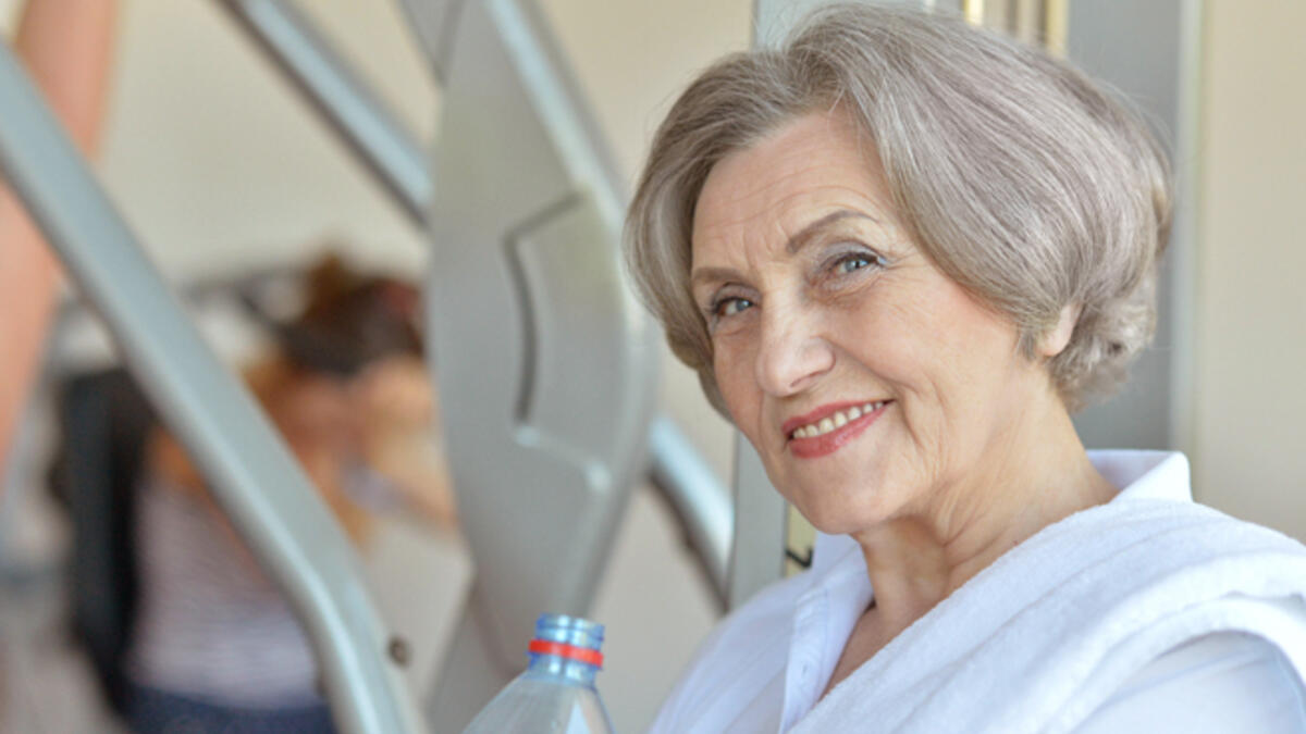 older woman exercising at gym