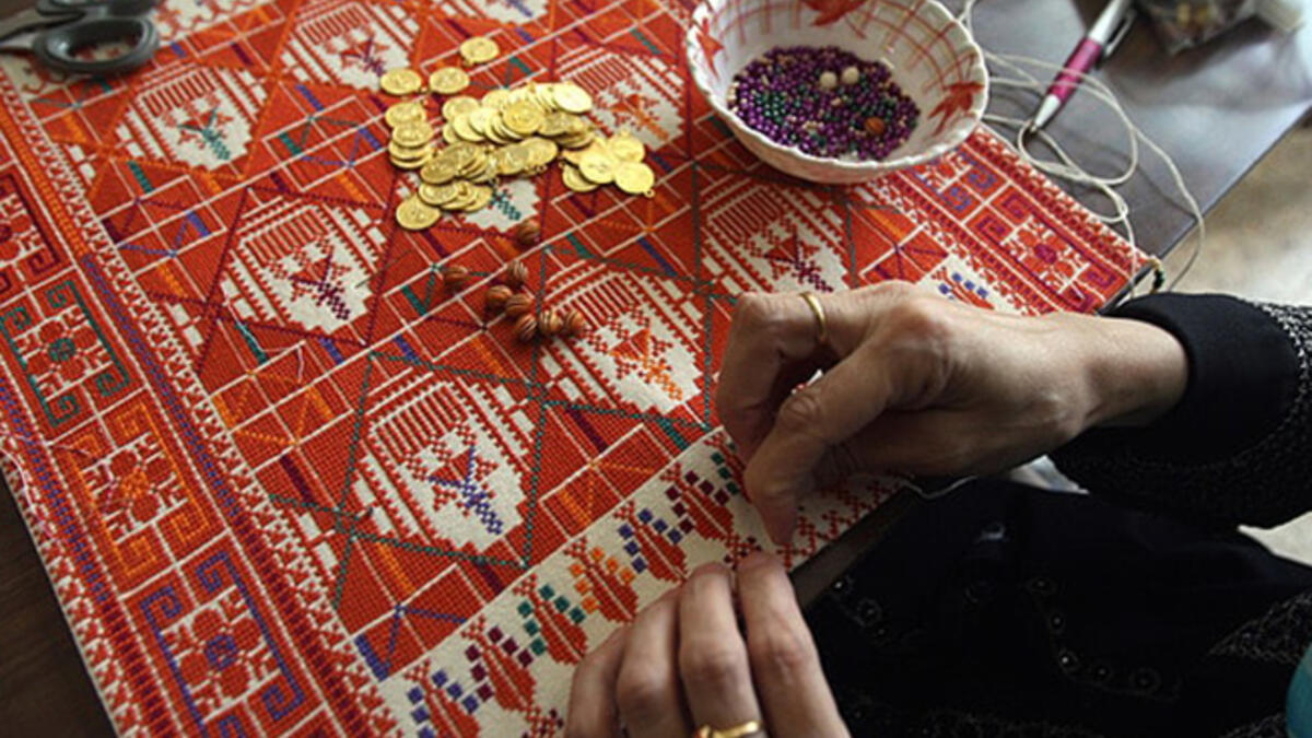 This 48-year-old Palestinian woman supports her family through home-based embroidery business while keeping the tradition alive. "By doing this work, which is part of our Palestinian heritage, I feel that women can renew our heritage and save it from extinction." (AFP)