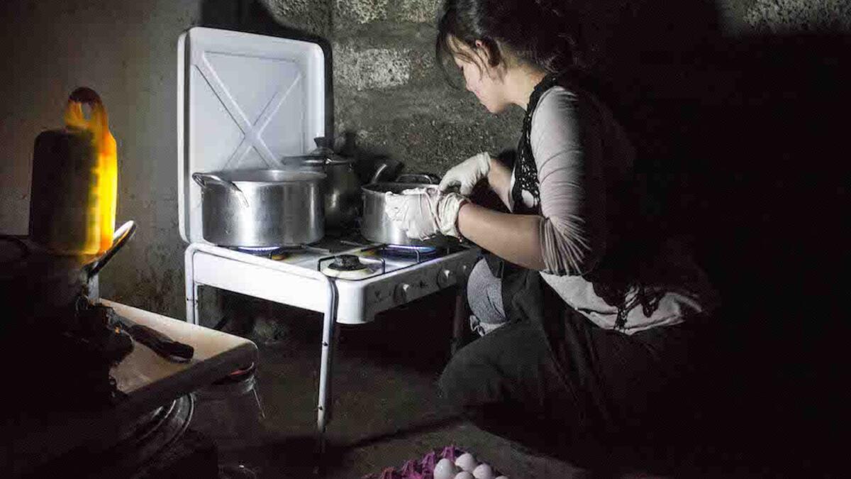 A Yazidi woman in the Khanke refugee camp in Iraq is boiling eggs to celebrate the new year. Eggs symbolize the earth, which is said to have been transformed from a liquid to a solid status, marking a new beginning of life.