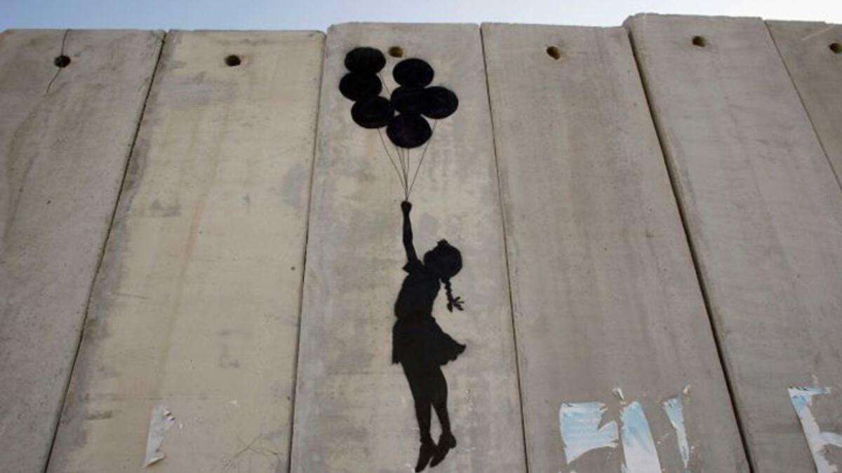 Visitors to his website are reminded that Israel’s 425-mile-long West Bank barrier, which separates Israel from Palestine is considered illegal by the United Nations. Banksy says the wall is "the ultimate activity holiday destination for graffiti writers.” Up, up and away!