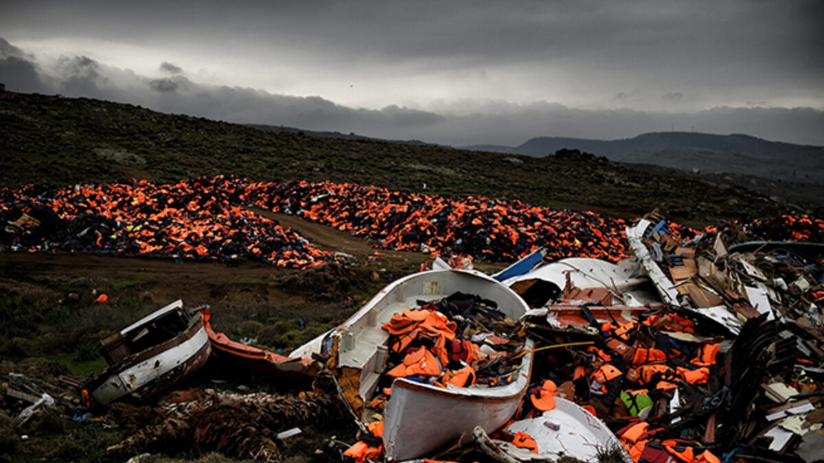 The debris of displacement: Thousands of discarded life jackets and plastic boats sits on a hillside on the Greek island of Lesbos.