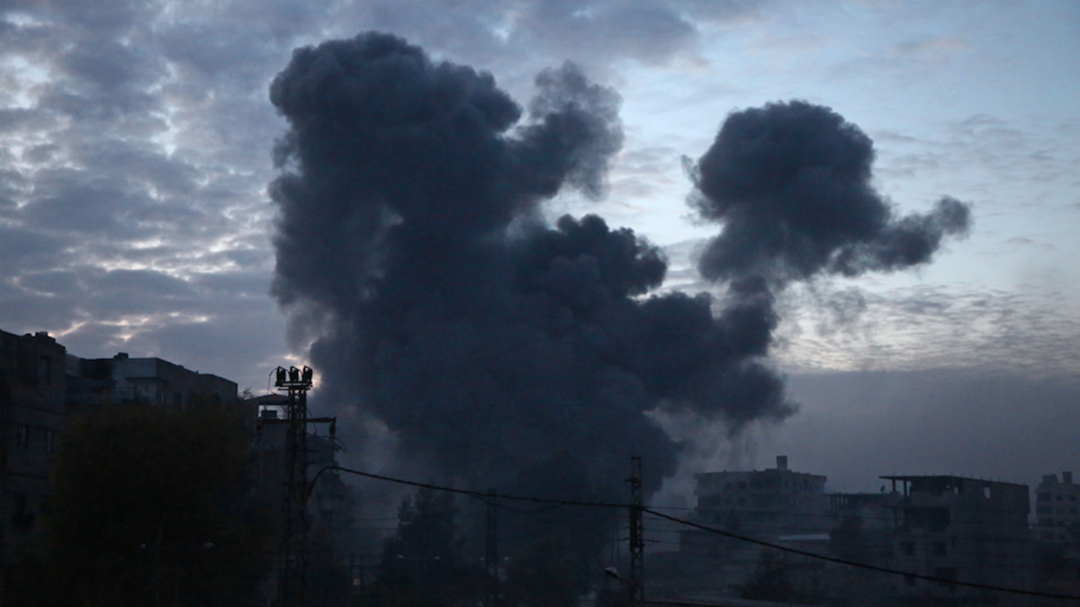 The bodies of civilians who were killed in Syrian army bombardment on the town of Hamouria in the rebel-held enclave of Eastern Ghouta are seen lying on the ground at a make-shift morgue the morning after the attacks on Feb. 20, 2018. 
(ABDULMONAM EASSA / AFP)