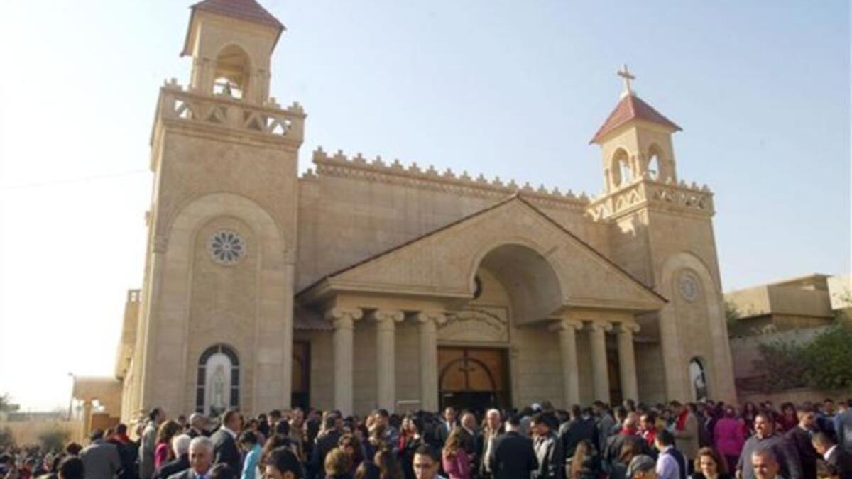 Iraqi Chaldean Catholics gather ouside the Cathedral of Kirkuk following Christmas day mass in northern Iraq.
