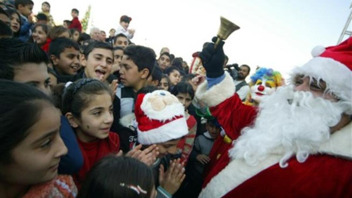 Mainly Iraqi Kurd children gather to greet Santa Claus in the northern Iraqi city of Arbil on Christmas eve.