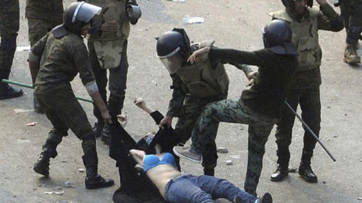 This 'blue-bra'd' girl is the iconic image for Egypt's post-revolution. Her graphic ordeal stands for indiscriminate violence to Muslim & Christian alike at the hands of the army. This veiled protestor was strewn in an undignified state when soldiers rough-handled her. Ripped apart at the seams, she diverted our eyes from the burning Churches.