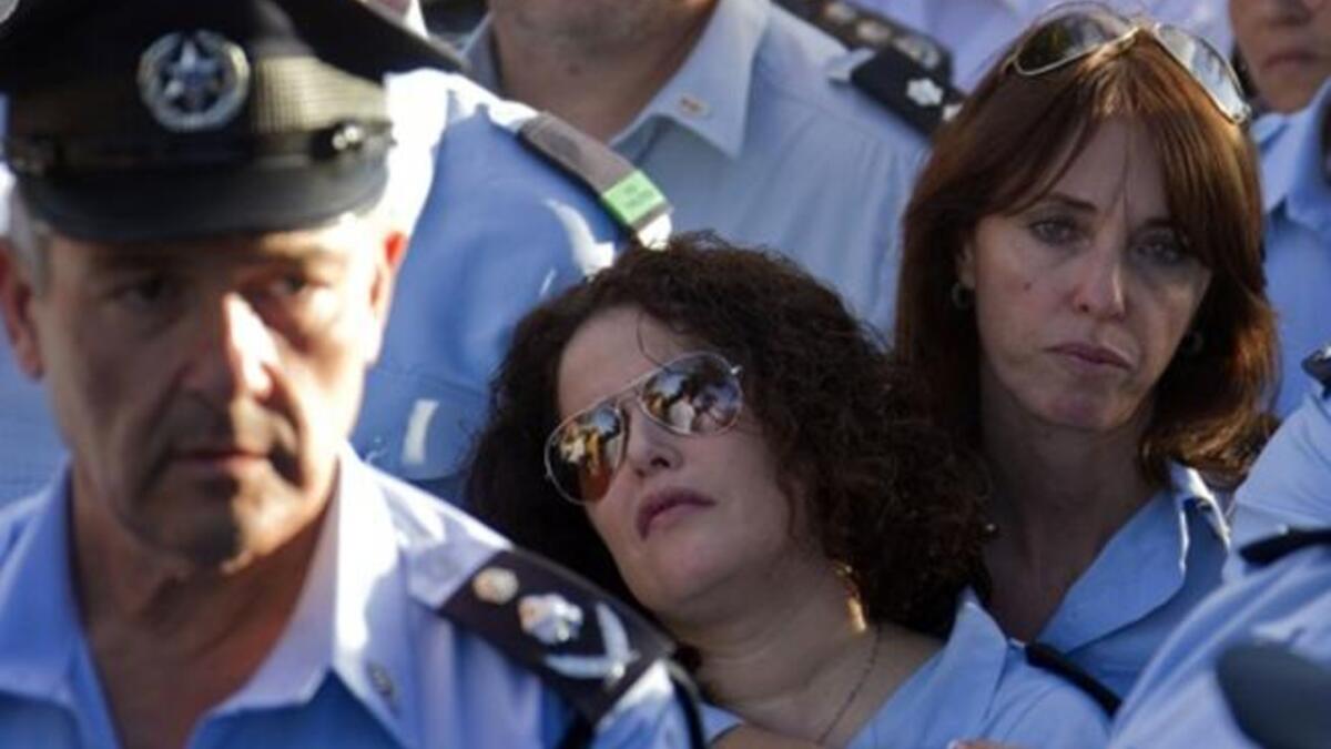 Israeli police officers mourn during the funeral of their comrade, Haifa Police Chief Ahuva Tomer. The death toll from Israelv massive forest fire rose to 42 with the death of Tomer, Israeli public radio reported.
