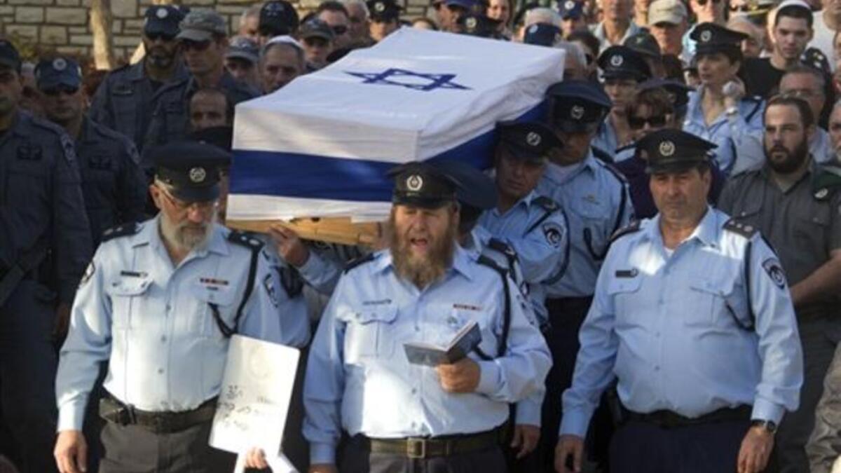 Israeli police officers carry the coffin of their comrade, Haifa Police Chief Ahuva Tomer, who died of her wounds after she was trapped with her car in raging fires which erupted in the Carmel Forest near Haifa.m