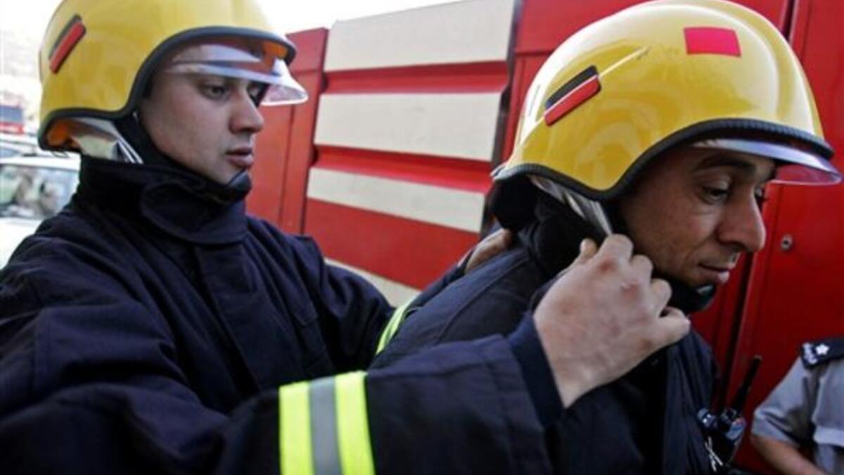 Palestinian firefighters get ready to cross the Israeli-controlled Jalama checkpoint near the West Bank city of Jenin, as they head to the Israeli city of Haifa to join the battle against a blazing Israeli forest.