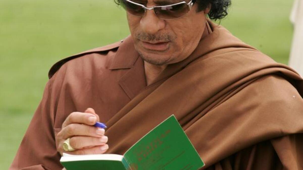 Gaddafi signs "The Green Book". The book is written by Gaddfi himself, contains controversial ideas about women, and it was first published in 1975.