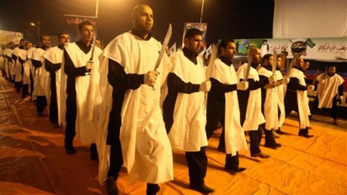 Members of The Promised day brigade, the military wing of Sadr movement, march during a parade marking the second festival of the Islamic resistance in Baghdad impoverished district of Sadr City.