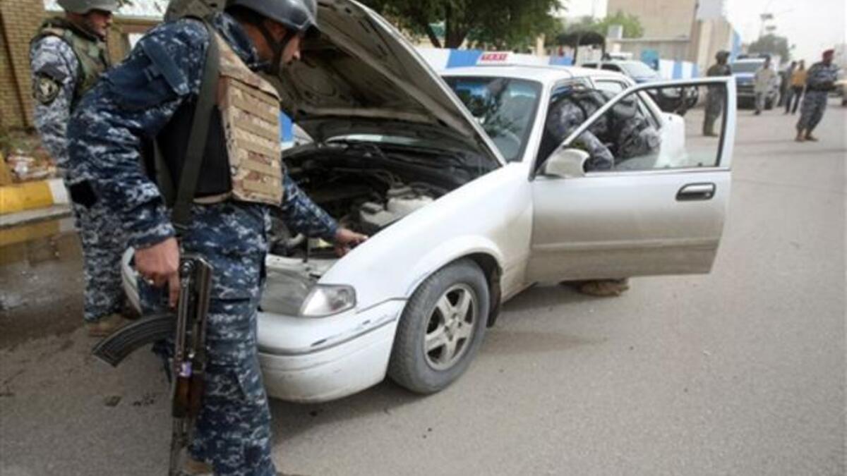 Iraqi troops implement strict security measures on main roads in Baghdad.