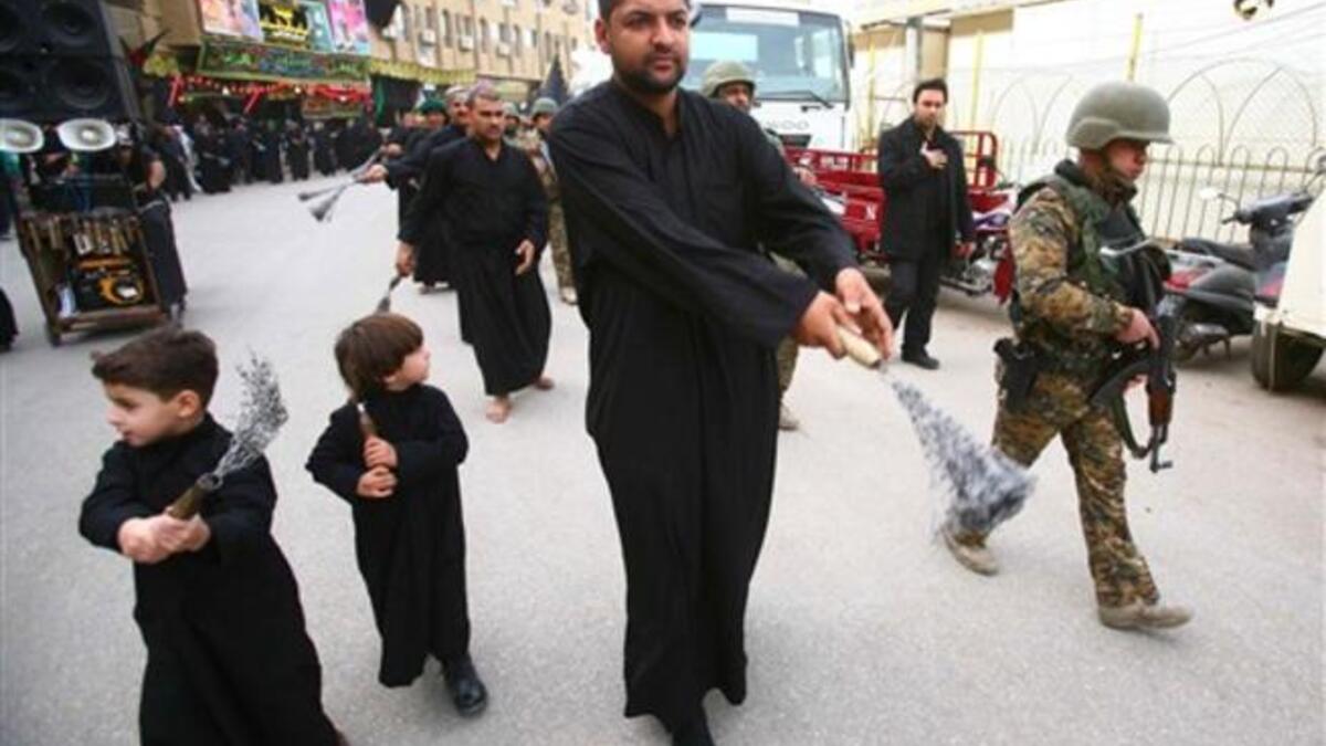 Iraqi soldiers protect a Shiite Muslim Ashura procession in the shrine city of Karbala in central Iraq.