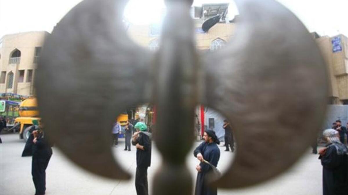 Shiite Muslim men flagellate themselves with chains in an Ashura ritual in the shrine city of Karbala in central Iraq, as believers prepare to mark the religious event of Ashura on December 17 in commemoration of ten days of mourning for Imam Hussein.