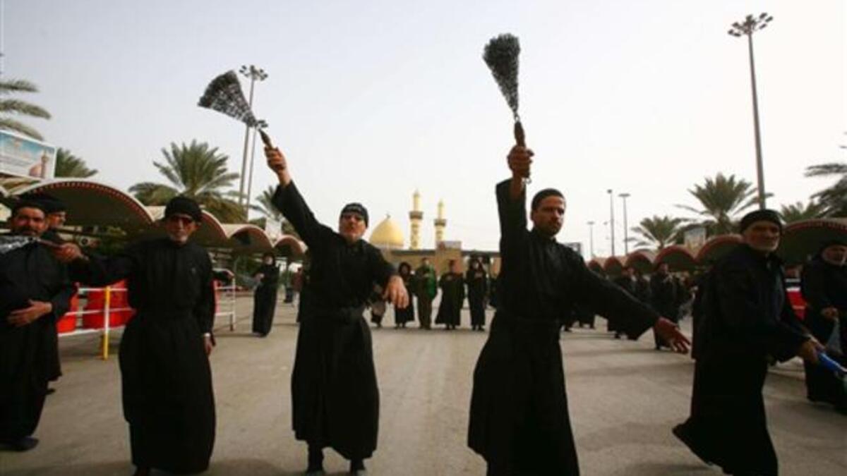 Shiite Muslim men flagellate themselves with chains in an Ashura ritual in the shrine city of Karbala in central Iraq, as believers prepare to mark the religious event of Ashura on December 17 in commemoration of ten days of mourning for Imam Hussein.