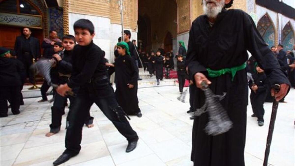 Shiite Muslim men and lads flagellate themselves with chains in an Ashura ritual in the shrine city of Karbala in central Iraq.