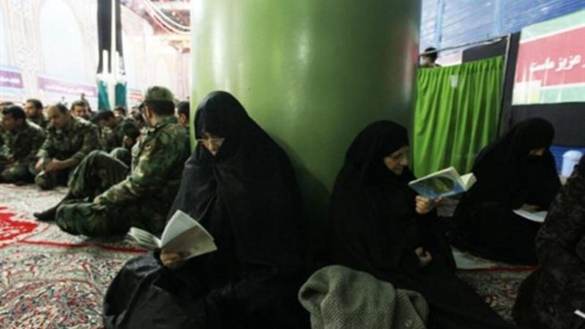 Iranian women read the Quran as they mark the 32nd anniversary of his return from exile at Khomeini's mausoleum in Tehran.