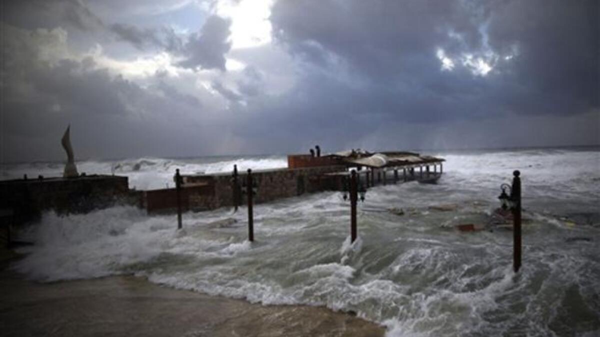 High waves flood a fish restaurant on the Mediterranean coast of the northern Lebanese port of Byblos.