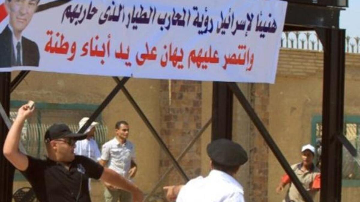 Mubarak supporters wave banners of the strongman.