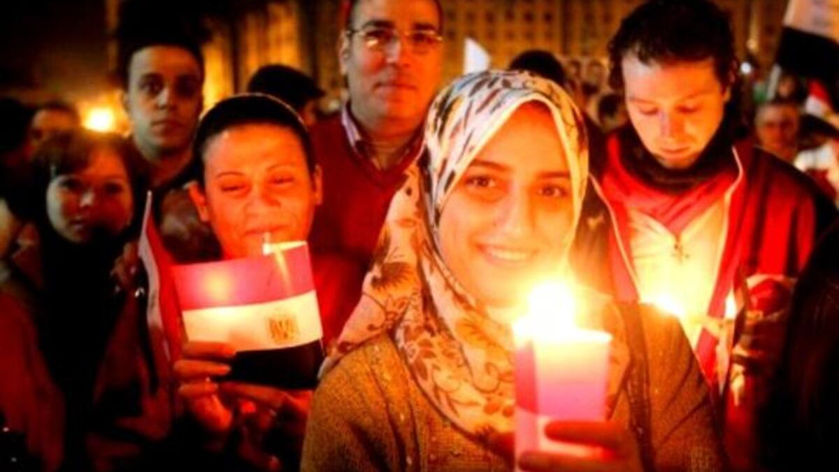 Thousands of Egyptian Muslims and Coptic Christians attend a celebration on New Year's eve in Tahrir Square in Cairo.