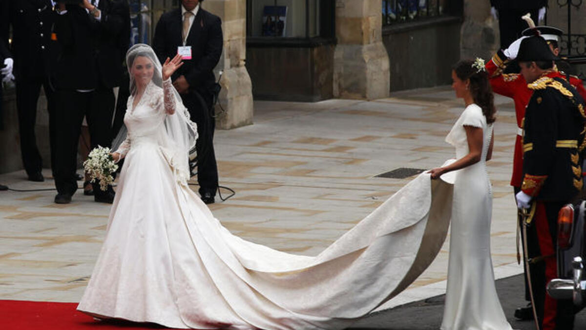 THE dress:10 years later she trades 'that' dress for this: Ivory ballgown from Alexander McQueen- a throwback to Grace Kelly's elegance- and model for brides-to-be who want that Catherine look complete with lacey arms. THIS dress walked down the mother-of-all catwalks, the Royal aisle & red carpet.