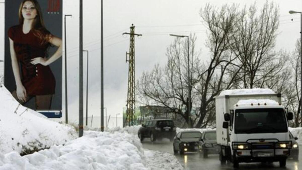 Traffic moves slowly in both directions on the main highway linking Beirut to Damascus near the mountain village of Sawfar during a snow storm which hit the Mediterranean country.
