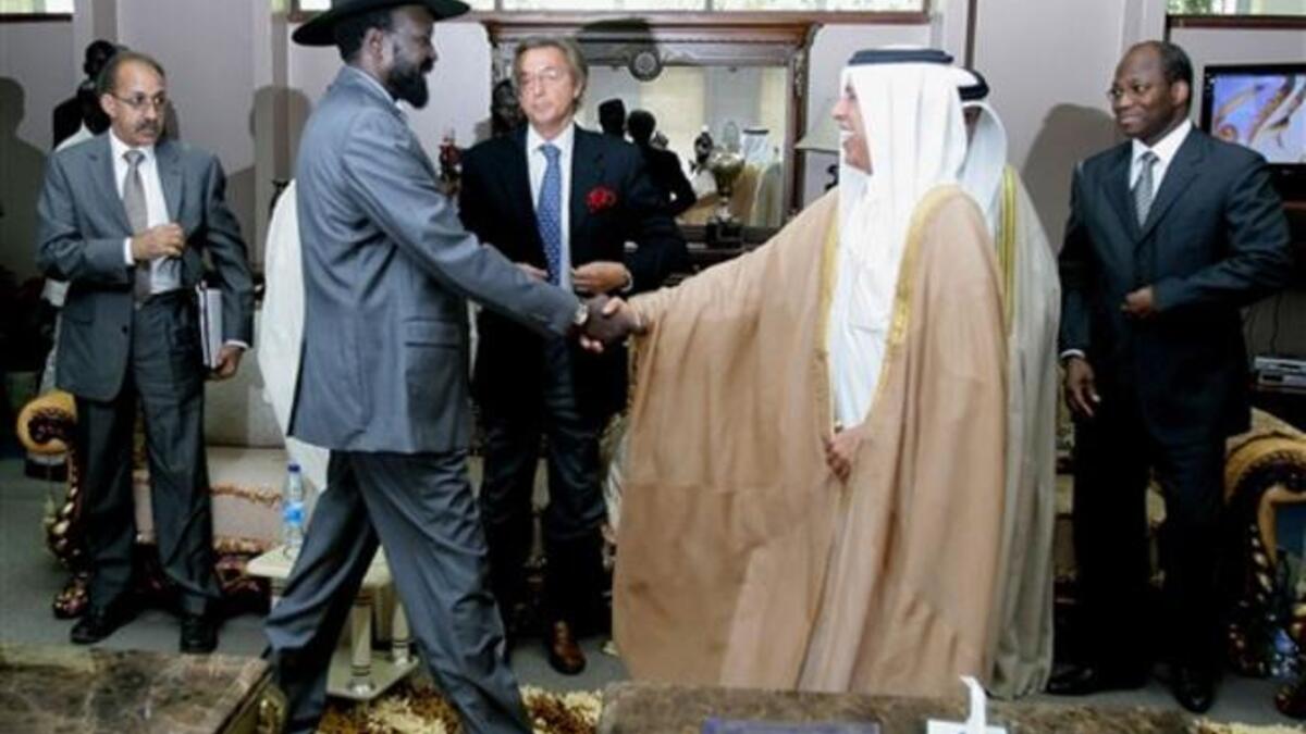 Qatari Minister of State for Foreign Affairs Ahmed bin Abdullah al-Mahmud (C-R) shakes hands with South
Sudan leader Salva Kiir as he arrives with Djibril Bassole, chief negotiator for the UN and the African Union for a meeting in south Sudan's regional capital Juba.