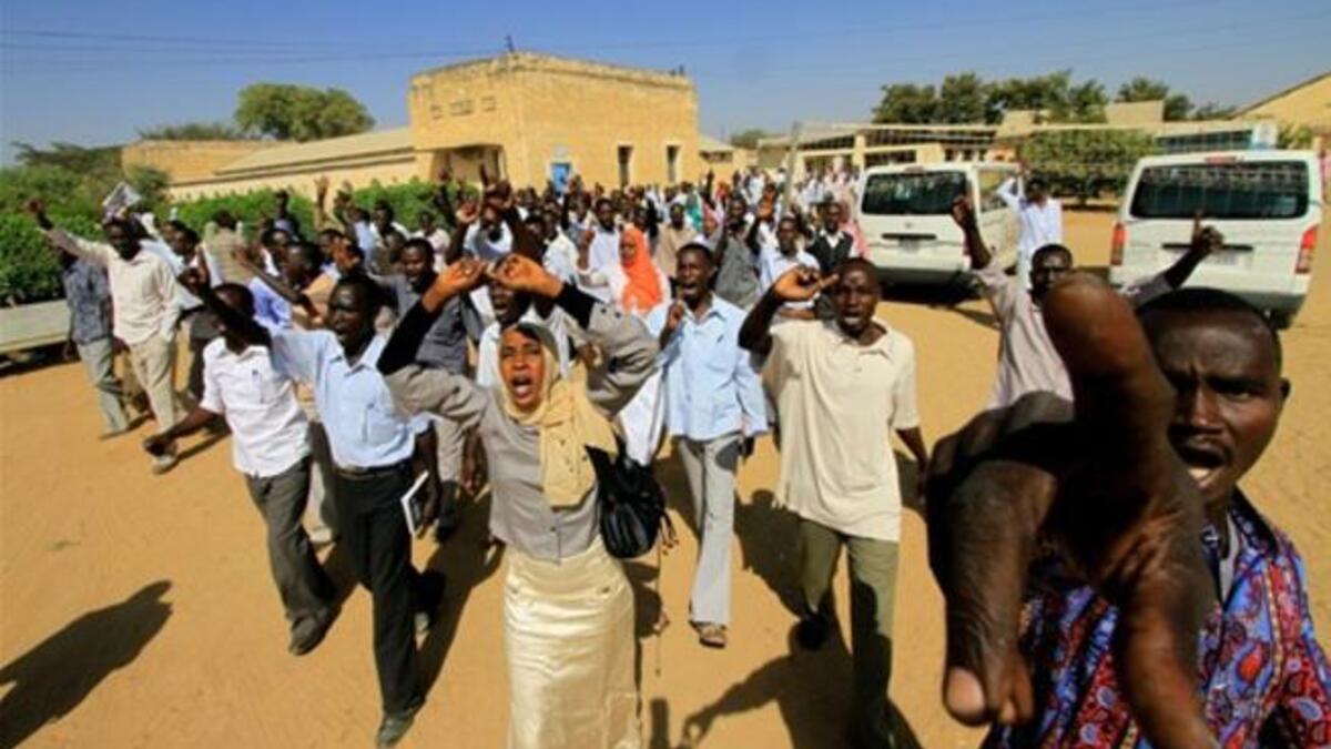 Sudanese students shout slogans during a protest against the visit of Darfur mediators from Qatar and the UN outside the University of Zalingei.