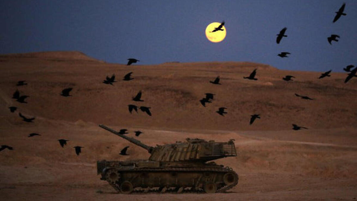 A picture taken on June 23, 2013 shows a full moon rising the "Judean Desert" in the Israeli occupied Palestinian West Bank.