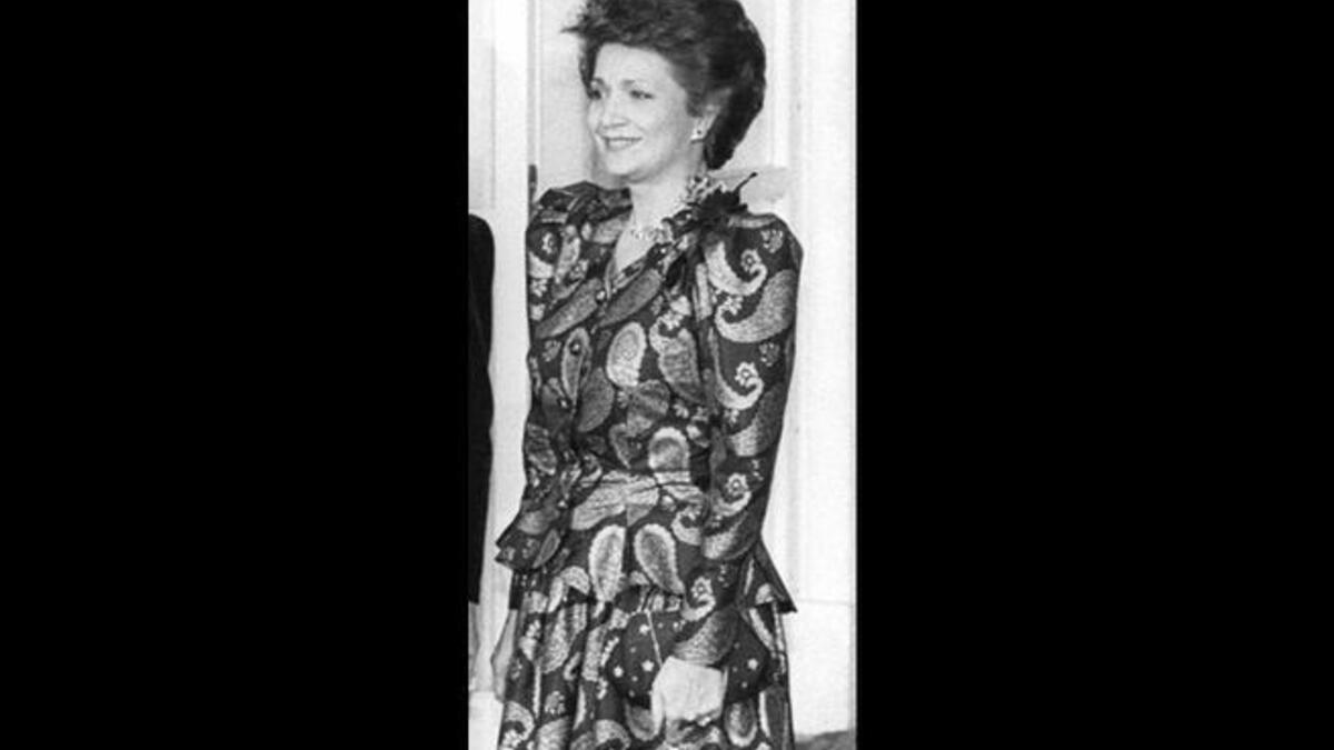 Played the high life but lived a 'low life', marked by dishonesty. She merged personal and philanthropic funds, most notoriously from the Alexandria Library. Here in 1988 pictured at a dinner at the White House, enjoying the glitz of state functions.