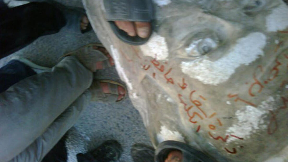 Hafez al-Assad falls in Darra: Protesters haul down a statue of President Assad's father, late president Hafez al-Assad, before security forces open fire from buildings.