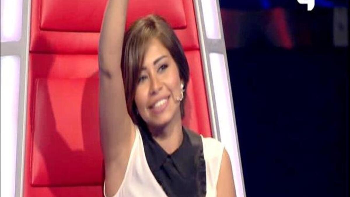 Sherine Abdel Wahab raises her arm