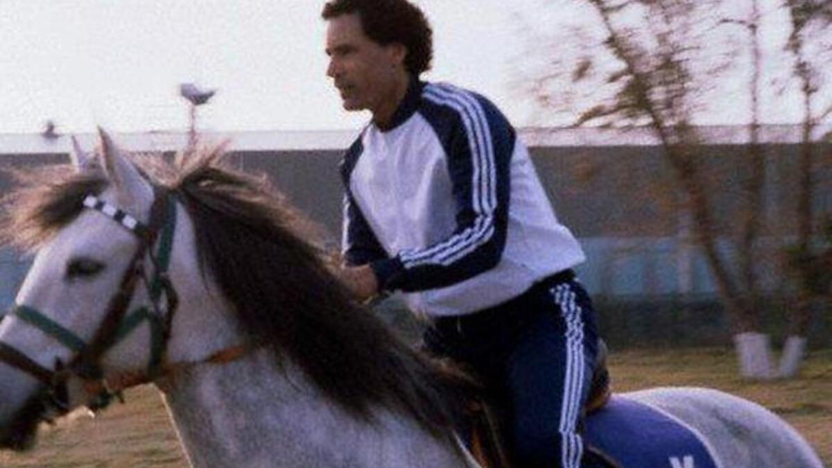 Young Muammar Gaddafi riding horse