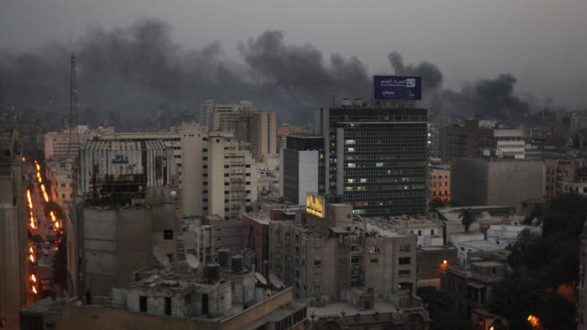Smoke billows up into the late evening sky.