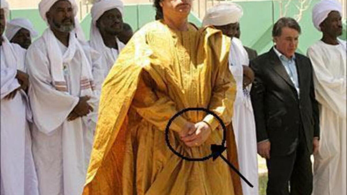 Another protocol botch: Holding his hands the incorrect wrong way round for Muslim prayer (should be right over left as the row of men behind demonstrate correctly)