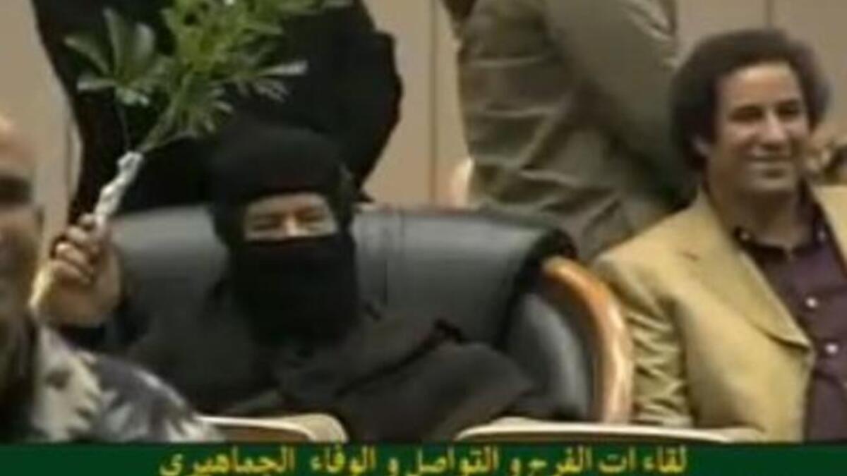 Ever theatrical: A member of the audience at a poetry recital, he demands attention with this his sprig of vegetation baton- as- prop.