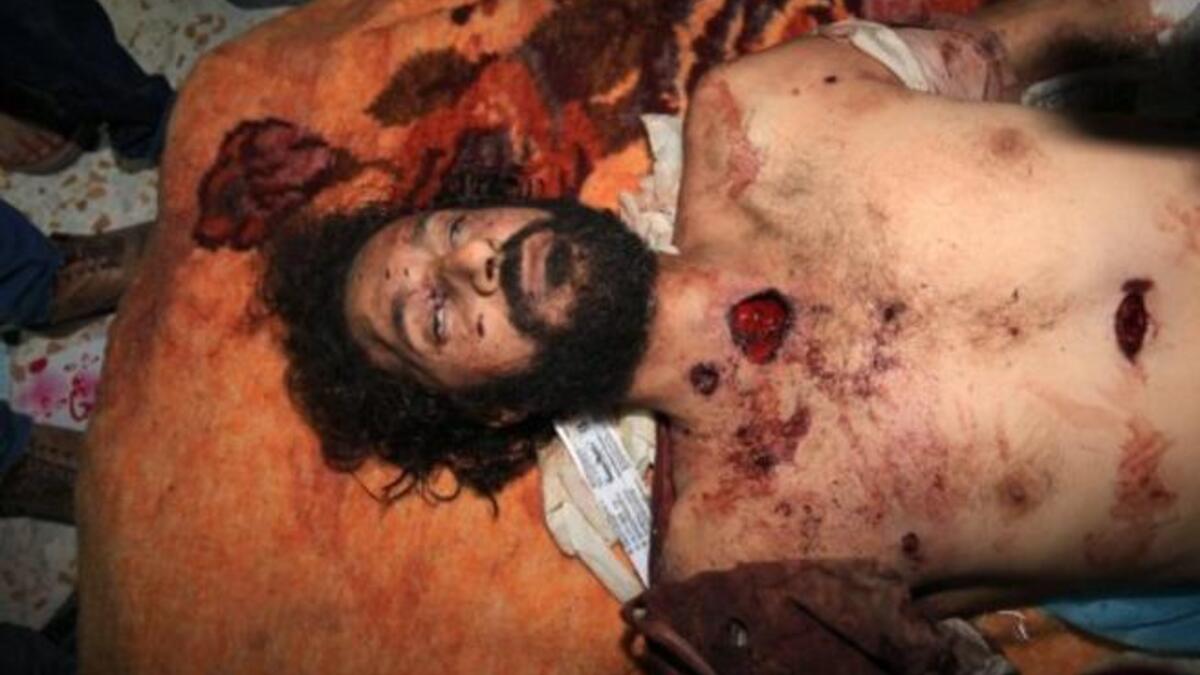 Son shares deathbed. The new regime found father & son together, senior Gaddafi waving a golden gun. His 5th sonwho stood by his Dad til the bitter end, went down with him, showing clan loyalty.  Said to lead a debauched lifestyle that his co-nationals disapproved of, Mutasam had fallen from dis-grace. The body of Mutassem Gaddafi, in Misrata.