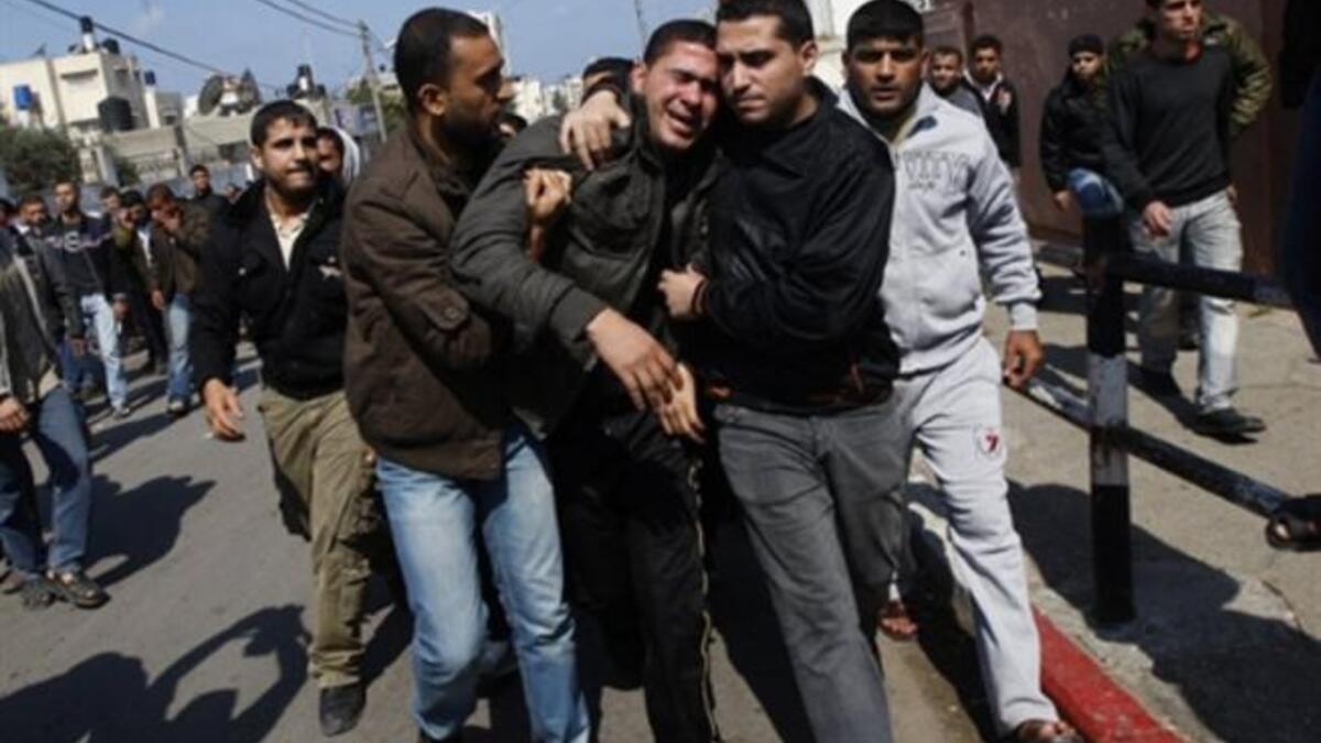 Palestinian mourners comfort each other during the funeral procession of Mohammed Atya Al-Harazine, a member of the Al-Quds Brigade, the armed wing of the Islamic Jihad, in Gaza.