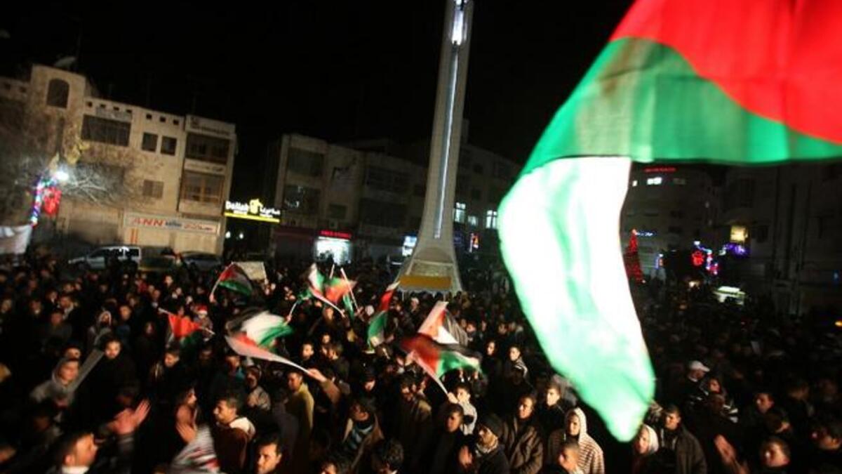 Palestinians of Ramallah see the New Year of 2013 in with flags