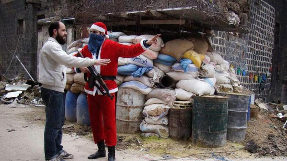Aleppo's Syrian Santa Claus bears AK-47, not gifts