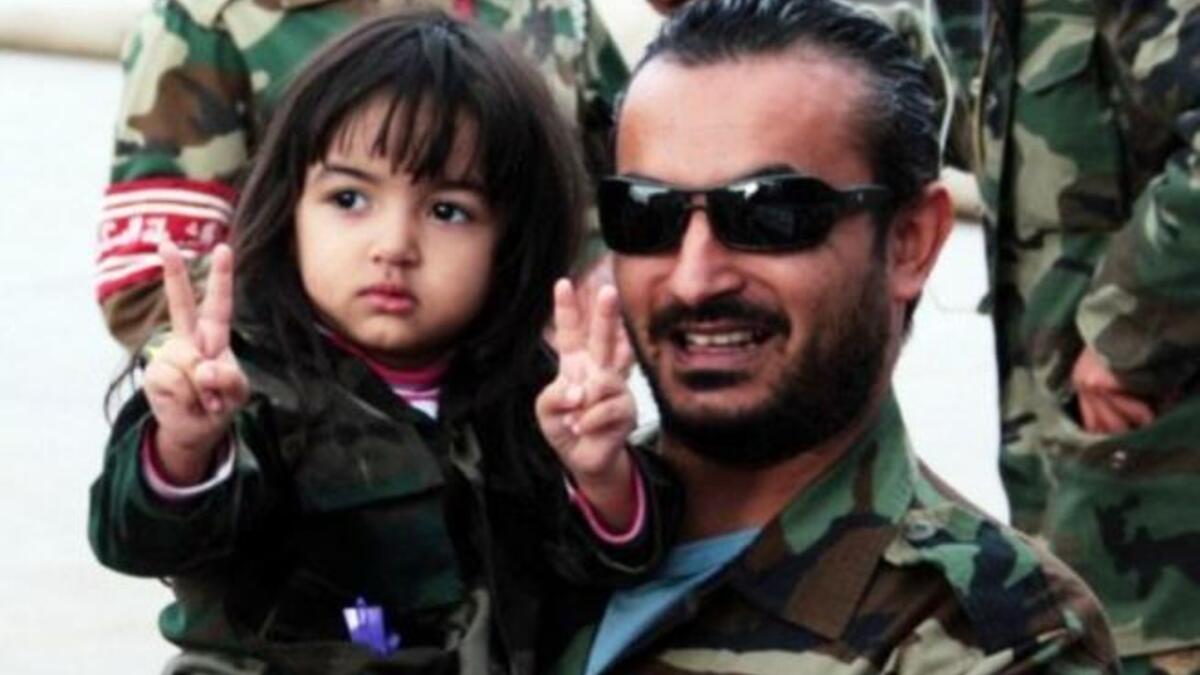A promising future awaits the new Libyan generation: A man celebrates with child the capture of once heir apparent of late father Colonel Gaddafi. Libyan leaders promise that his second son will be tried in the International Criminal Court (ICC), and held to account for charges against him, possibly answering to the crimes of his untried father.