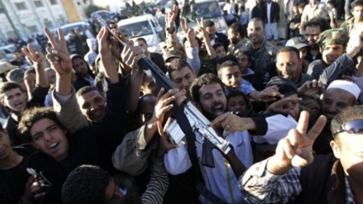 Brandishing a gun claimed as al-Islam's, the jubilant crowds hail a victory in their struggle for power & a clean break from the old Gaddafi family dictatorship. Empowered & liberated, they applaud their seizure of the last 'fighting' flesh of Gaddafi. Most are happy to hand him over to international courts, while he refuses to recognize the ICC.