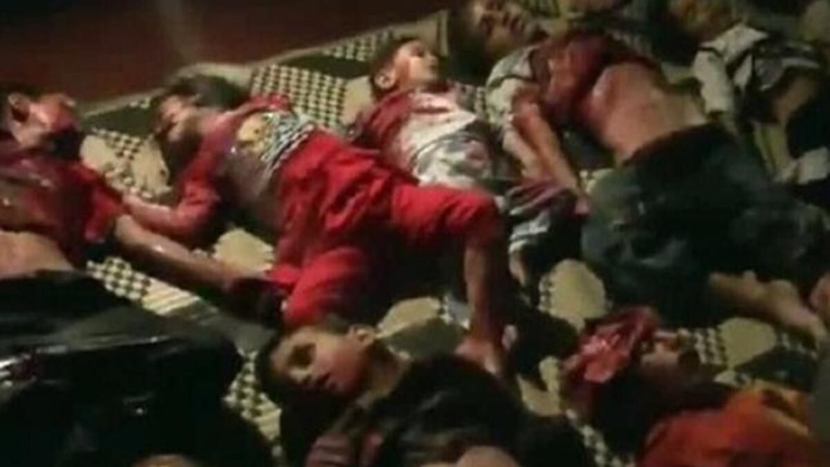 صف من الأطفال الذين ذبحوا في الحولة