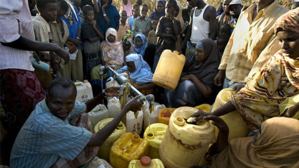 Somali refugees wait for water, Dadaab, Kenya. The three camps at Dadaab, which were designed for 90,000 people, now have a population of about 250,000 Somali civilians (AFP)