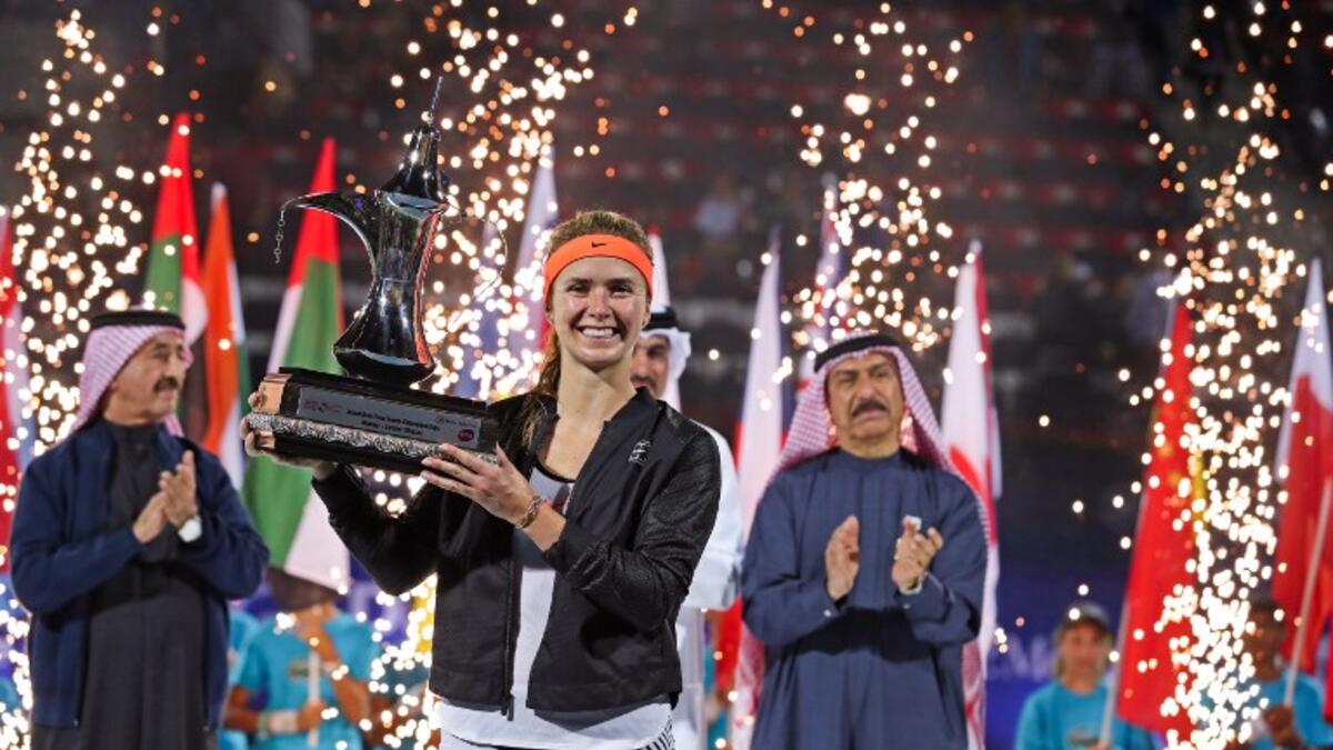Elina Svitolina of Ukraine celebrates with the trophy after winning the final women's WTA Tennis Championship match in Dubai on February 25, 2017. Svitolina beat Denmark's Caroline Wozniacki 6-4, 6-2 to win a rain-delayed final.
KARIM SAHIB / AFP